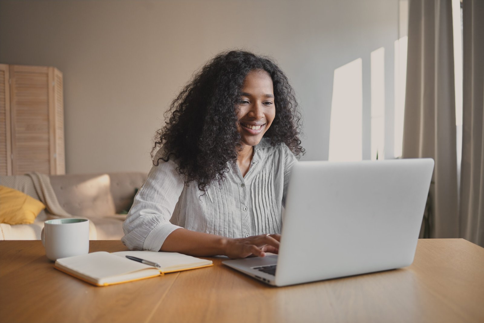 A young African professional working on her laptop